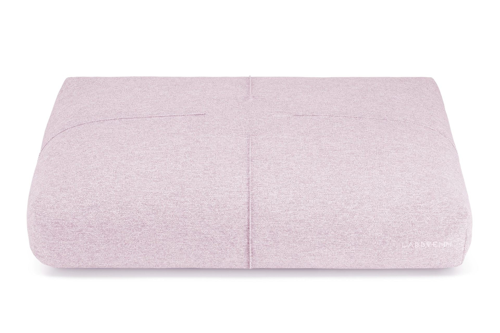 soft pink finno dog cushion with elegant stitching on a cozy bed