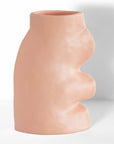 soft pink ceramic vase on a cozy living room shelf, glowing with morning light