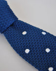 navy blue skinny knitted tie with white polka dots and pointed end