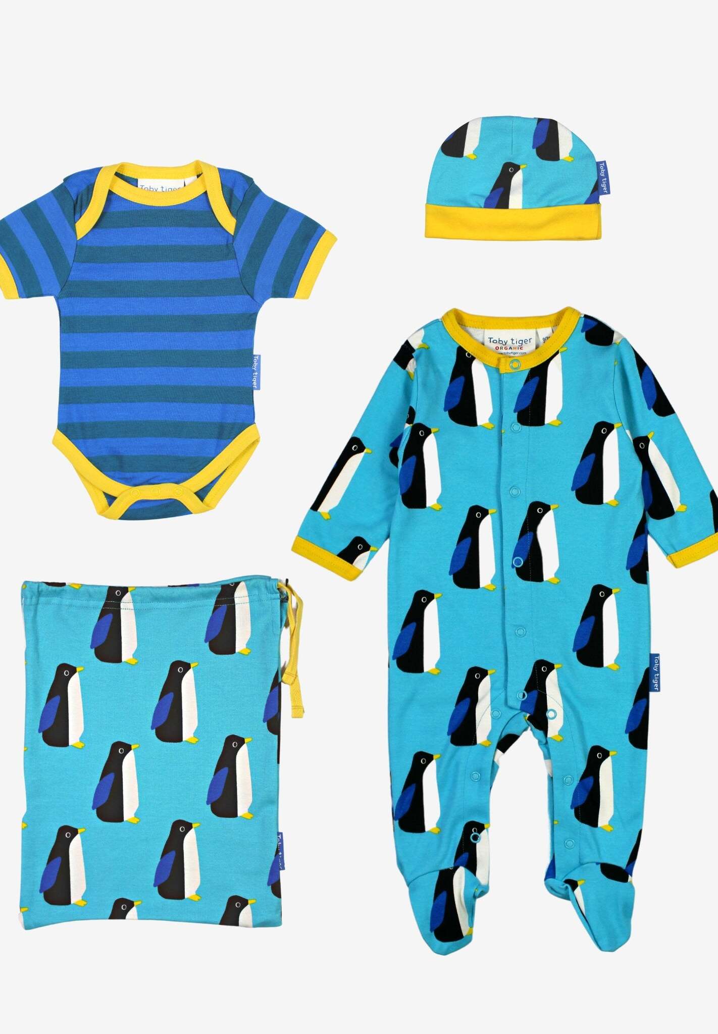 Premium Organic Baby Clothes Set with Penguin Print, Hat, and Tote Bag in Soft Blue and Yellow by Toby Tiger at brixbailey.com