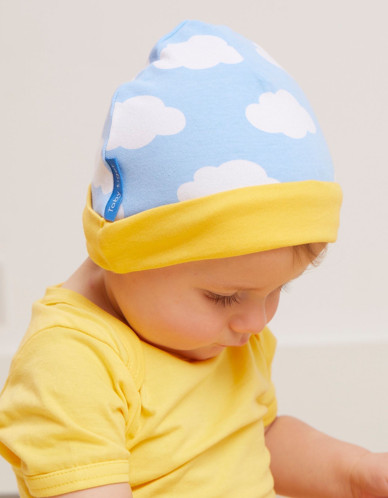 Premium Organic Cotton Baby Gift Set with Hat, Onesie and Romper in Adorable Sun and Clouds Print by Toby Tiger at brixbailey.com