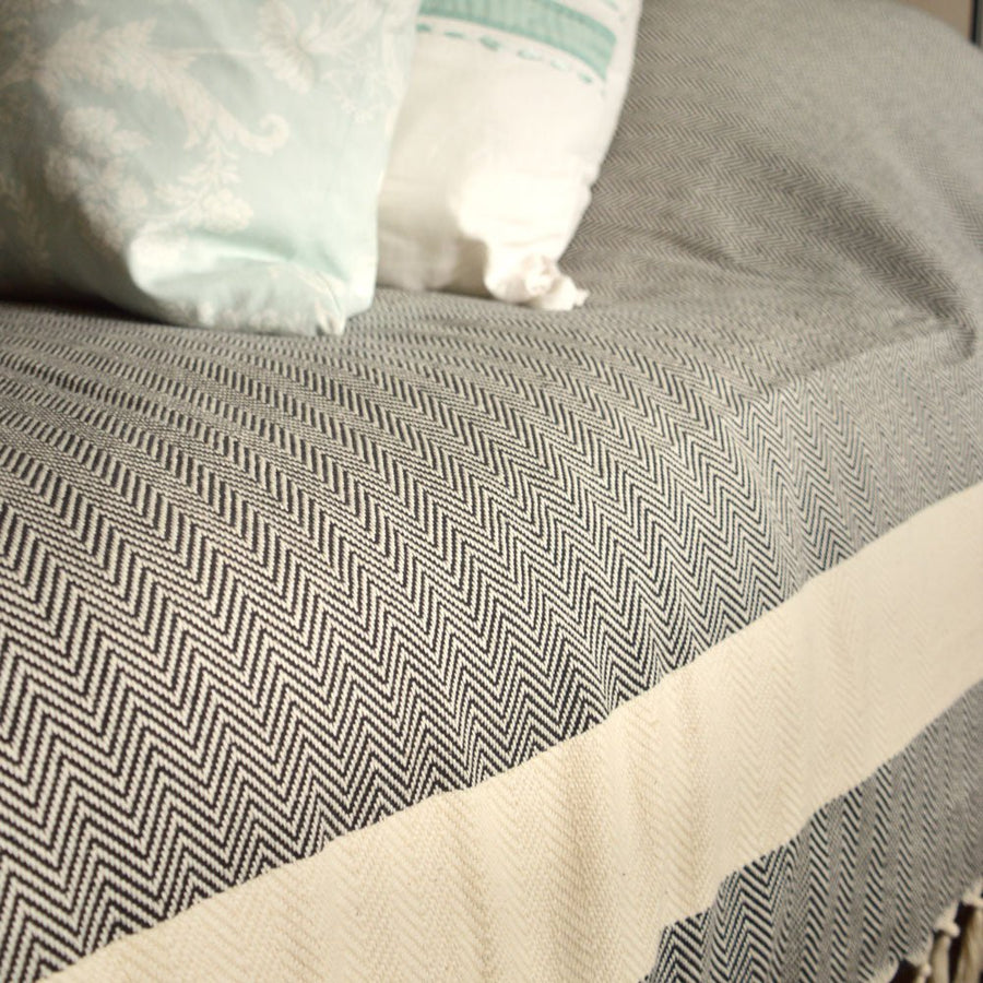 Harrington Bed Throw XL, luxury oversized organic cotton blanket, black with natural zig-zag stripe, handloomed herringbone design, king size by Wildash London at brixbailey.com