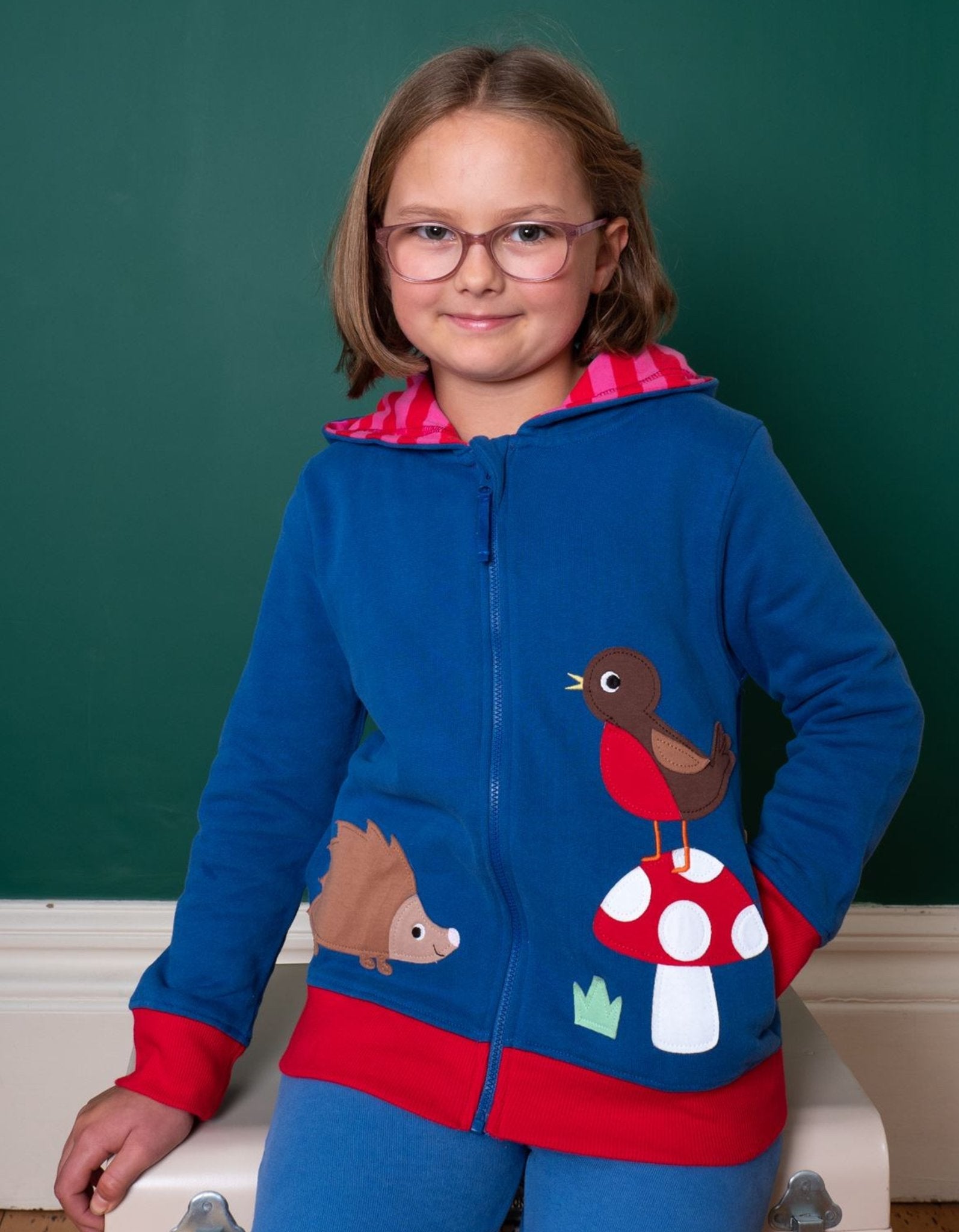 Premium organic cotton hoodie with floral mushroom embroidery, striped fleece lining, certified GOTS, eco-friendly dyes, cozy autumn navy blue by Toby Tiger at brixbailey.com