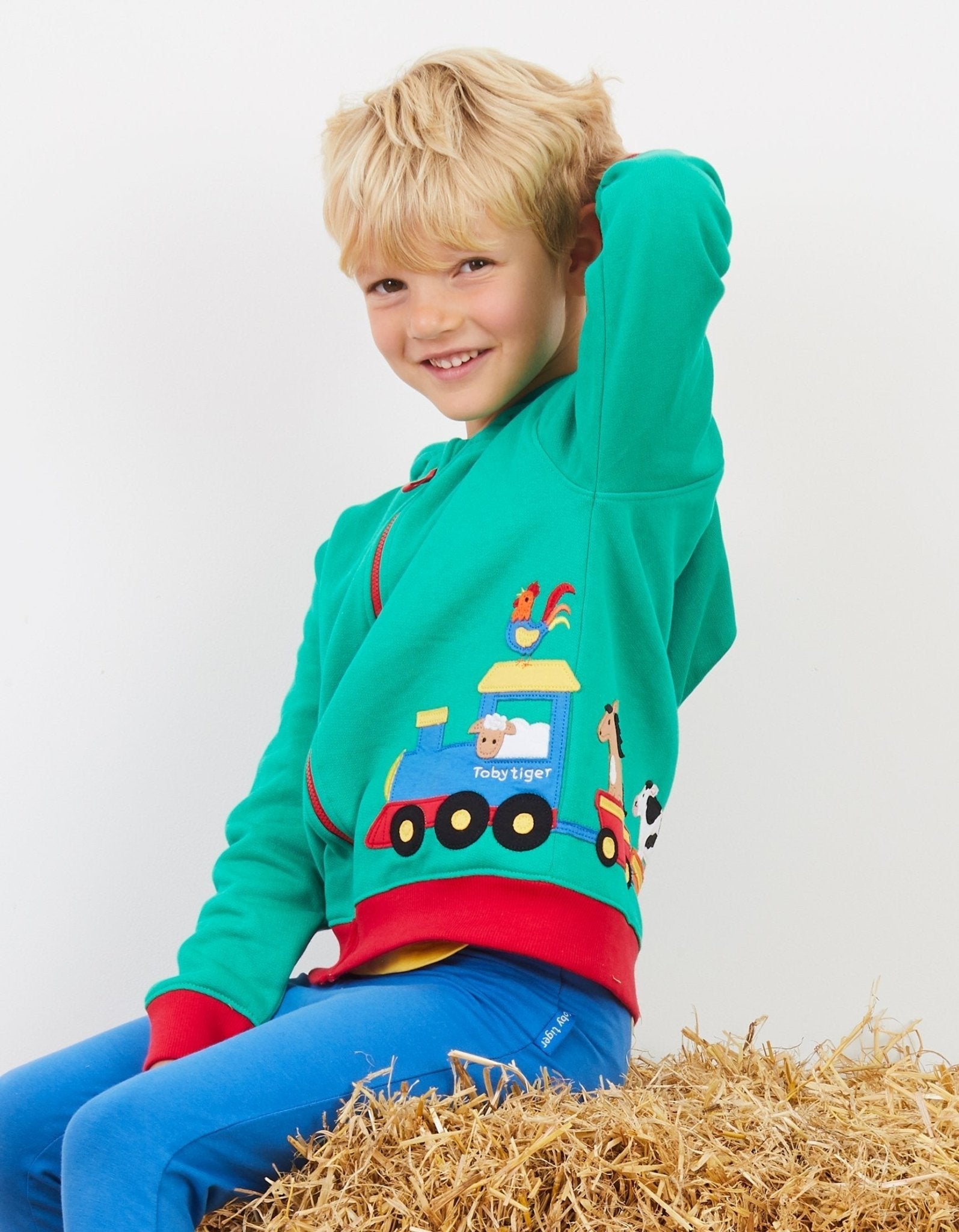 Premium green hoodie with train applique, soft organic cotton, Toby Tiger design, cozy jersey lining, GOTS certified by Toby Tiger at brixbailey.com