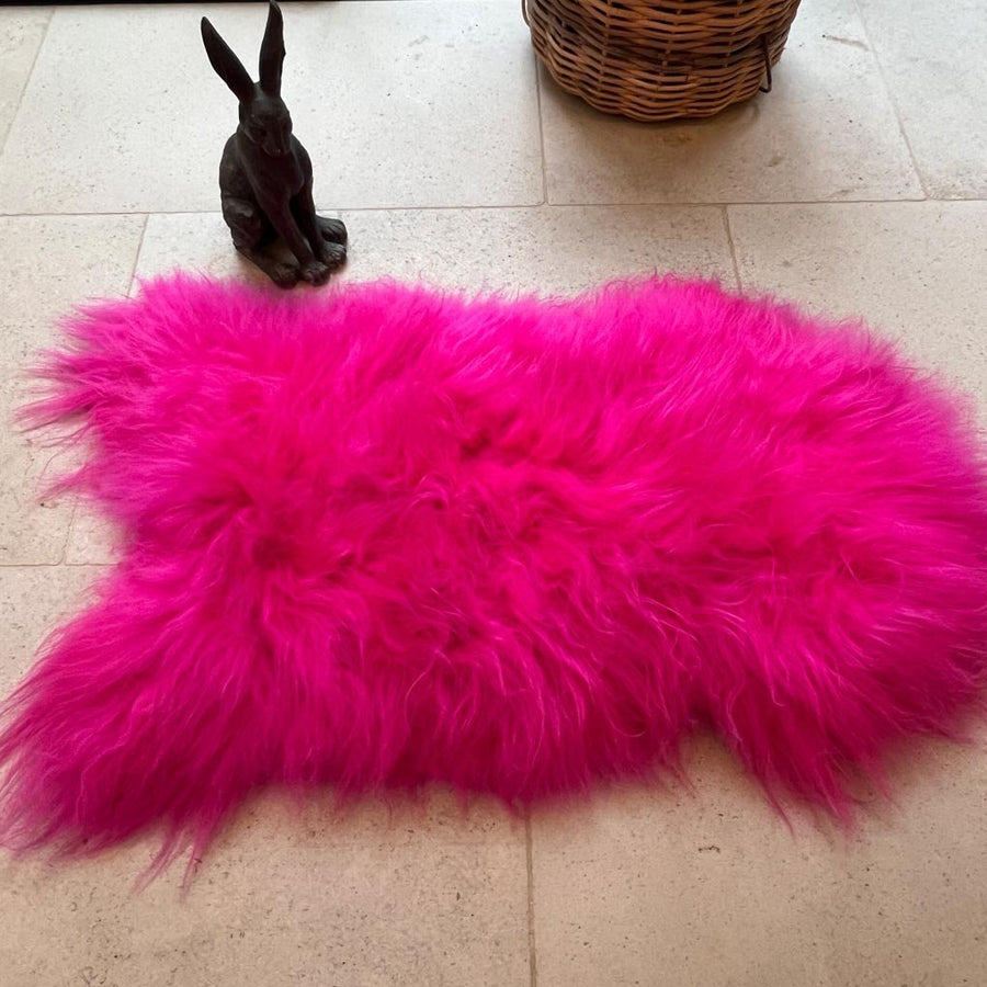 Luxury hot pink sheepskin rug, premium Icelandic sheepskin throw, large 100-110cm, soft long fur, stylish home decor, best-selling statement piece by Wildash London at brixbailey.com