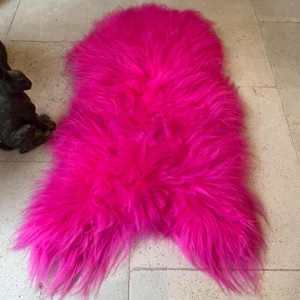 Luxury hot pink sheepskin rug, large Icelandic throw, premium natural fur, 100-110cm, stylish home decor, best-selling vibrant statement piece by Wildash London at brixbailey.com