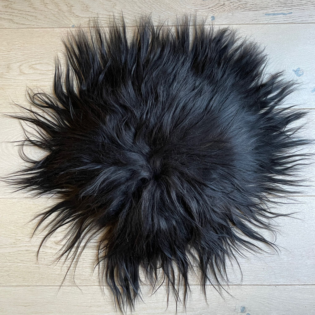 Luxury Icelandic sheepskin round seat cover, natural black long fur, premium handcrafted 35cm hide, sustainable hypoallergenic by Wildash London at brixbailey.com