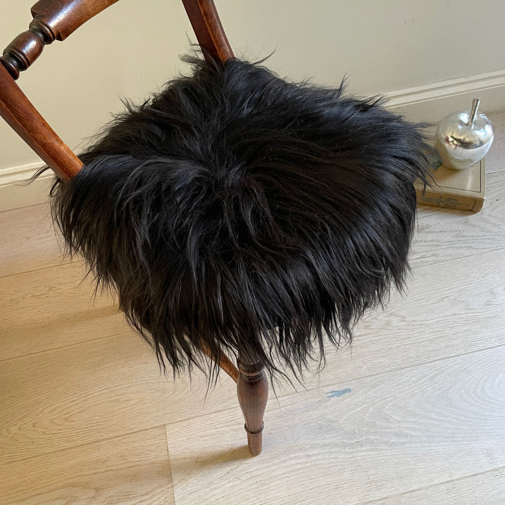 Luxury Icelandic sheepskin round seat cover, natural black long fur, 35cm diameter, premium handcrafted sheepskin hide by Wildash London at brixbailey.com