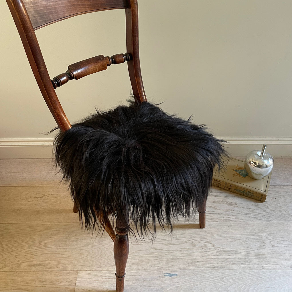 Luxury Icelandic sheepskin round seat cover, natural black long fur, 35cm diameter, premium handcrafted sustainable sheep hide by Wildash London at brixbailey.com