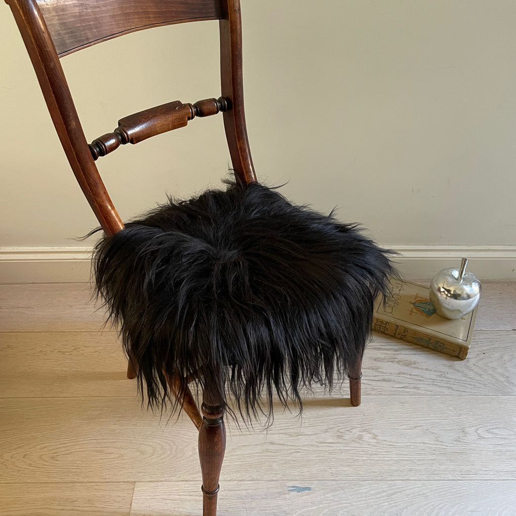 Luxury Icelandic sheepskin round seat cover, natural black long fur, 35cm diameter, premium handcrafted sustainable sheep hide by Wildash London at brixbailey.com