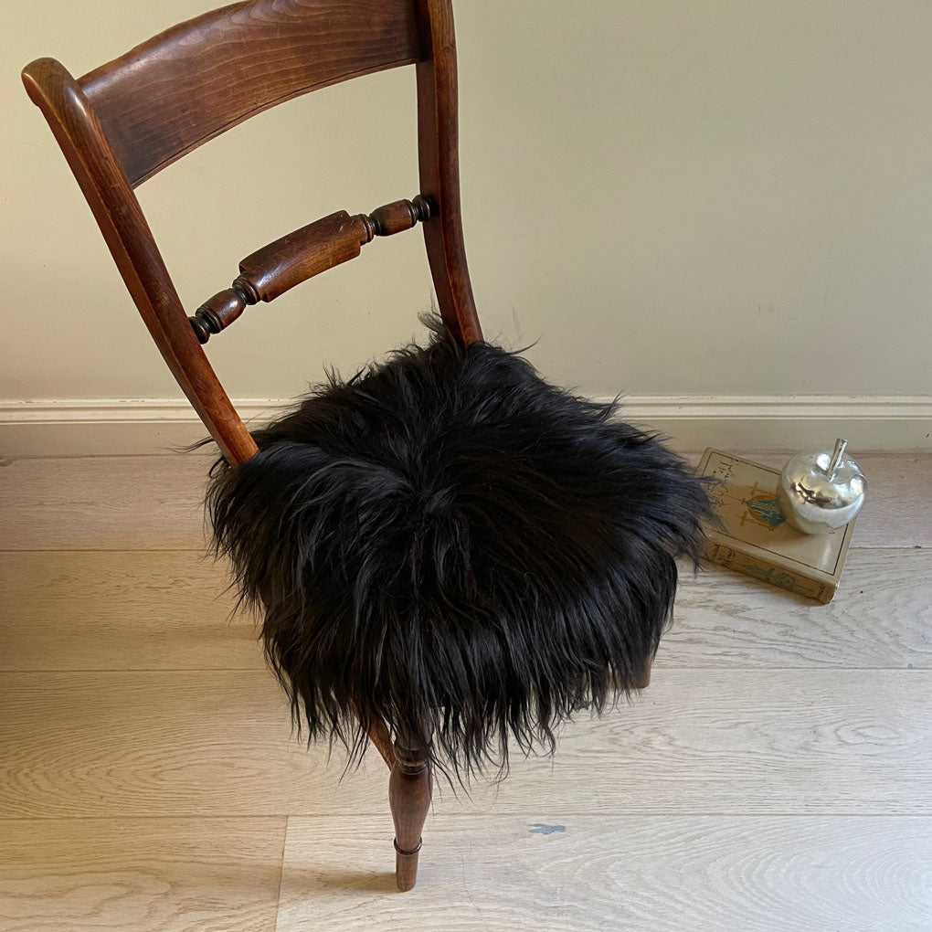 Luxury Icelandic sheepskin round seat cover, natural black long fur, 35cm diameter, premium handcrafted sustainable sheepskin by Wildash London at brixbailey.com