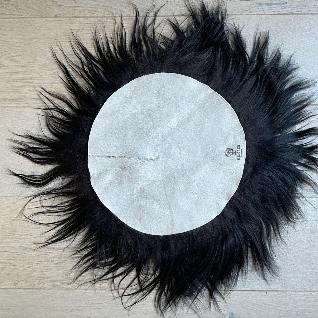Luxury Icelandic sheepskin round seat cover, natural black long fur, 35cm diameter, premium handcrafted sustainable sheep hide by Wildash London at brixbailey.com