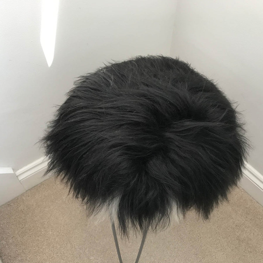 Luxury Icelandic sheepskin seat cover, natural black and white long fur, premium handcrafted roundie, 35cm diameter, sustainable and hypoallergenic by Wildash London at brixbailey.com