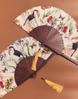 Floral Silk Fan with Toucan design and luxurious Gold tassel, part of the Mysa Collection