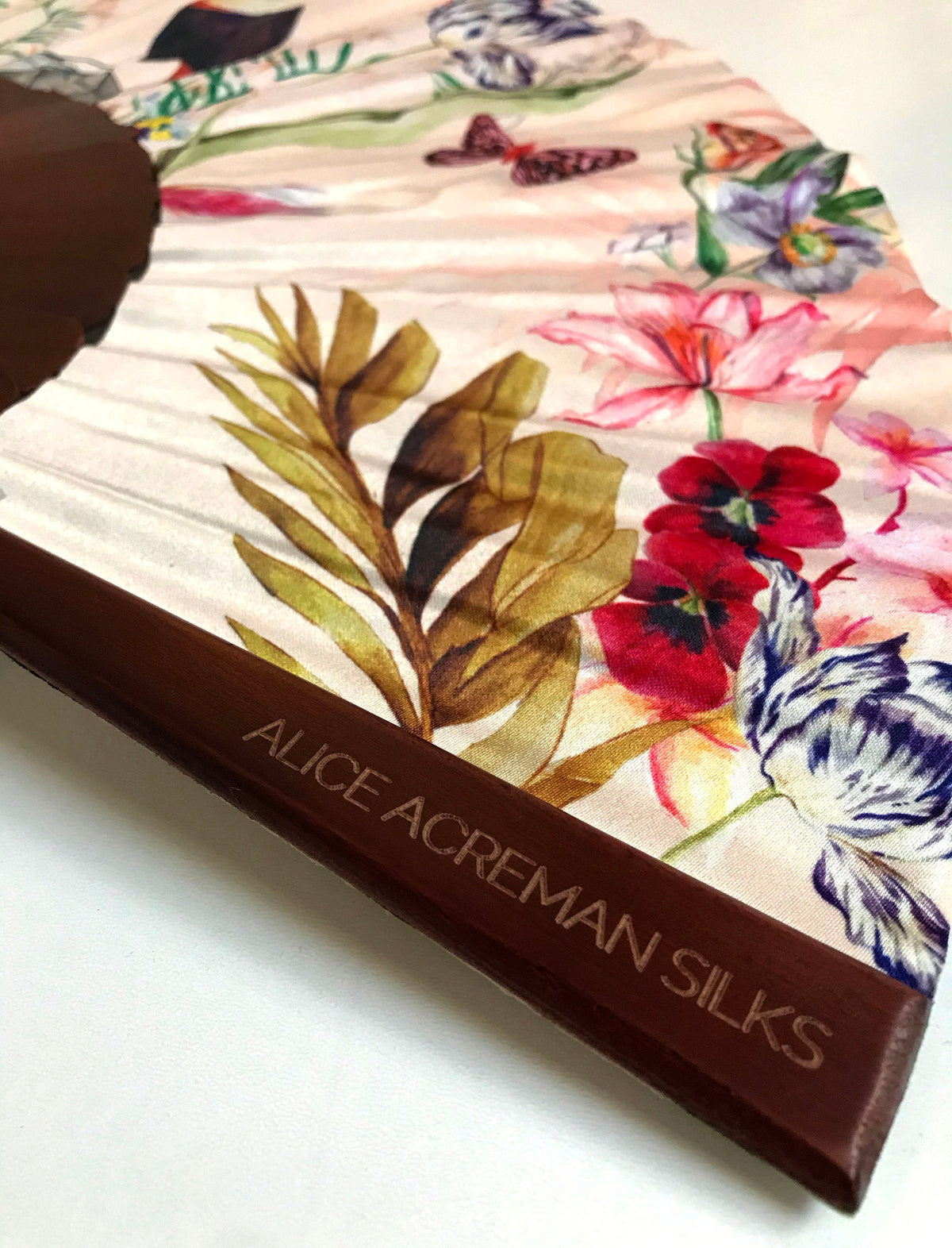 Floral Silk Fan with Toucan design and luxurious Gold tassel, part of the Mysa Collection