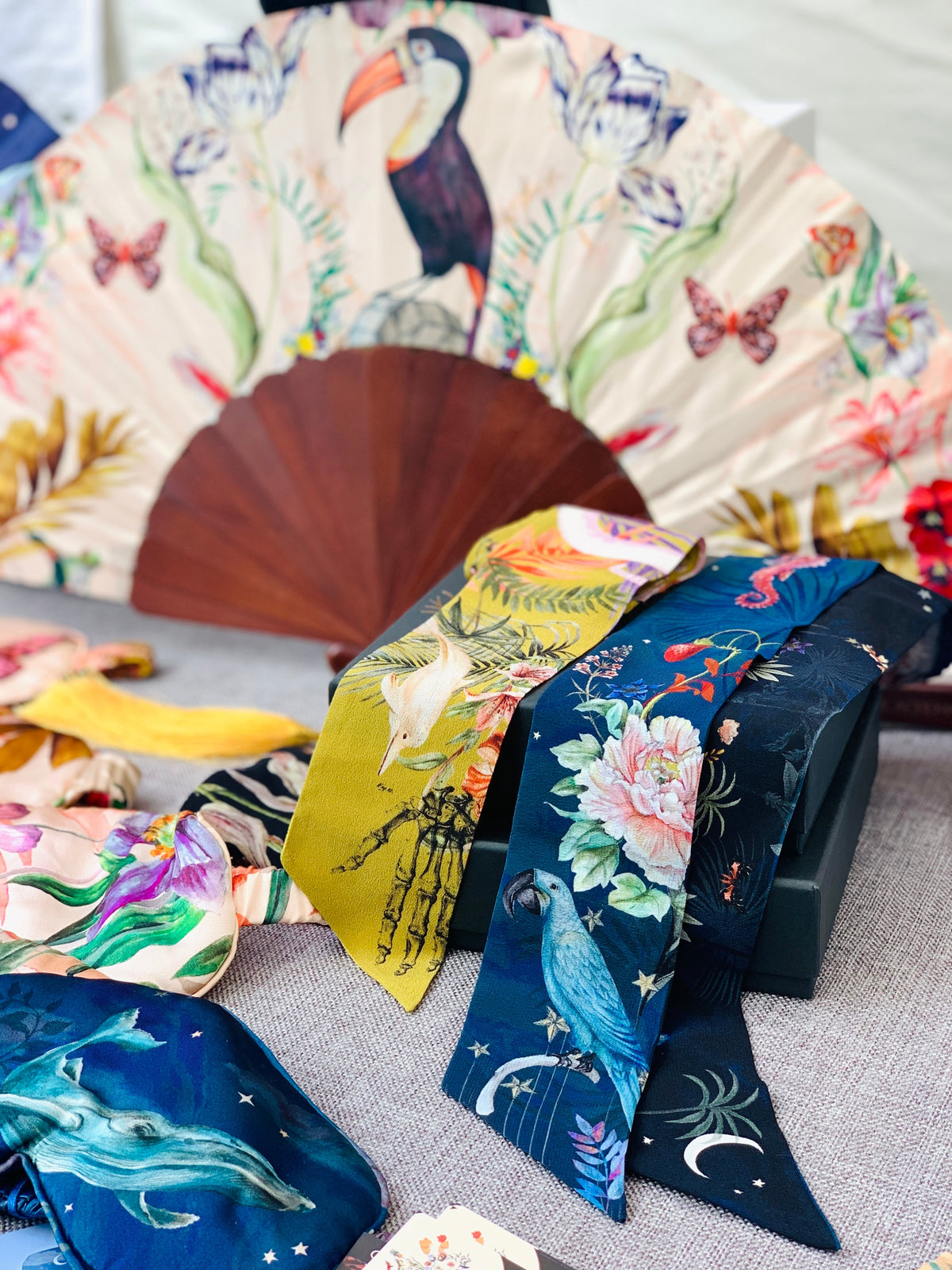 Floral Silk Fan with Toucan design and luxurious Gold tassel, part of the Mysa Collection