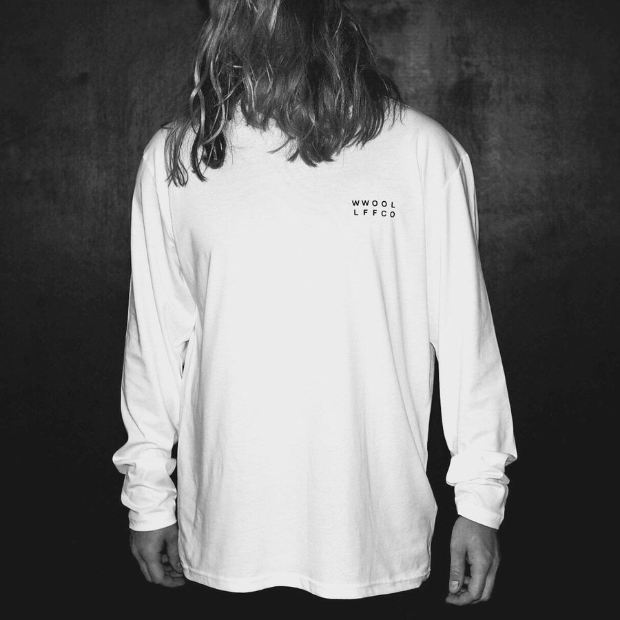 Oversized white long sleeve with handprinted WWOOLLFF CO. graphics, premium organic cotton, stylish unisex design by WWOOLLFF CO. at brixbailey.com