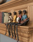 Wooden shelf with figurines of people playing instruments on a wooden wall.
