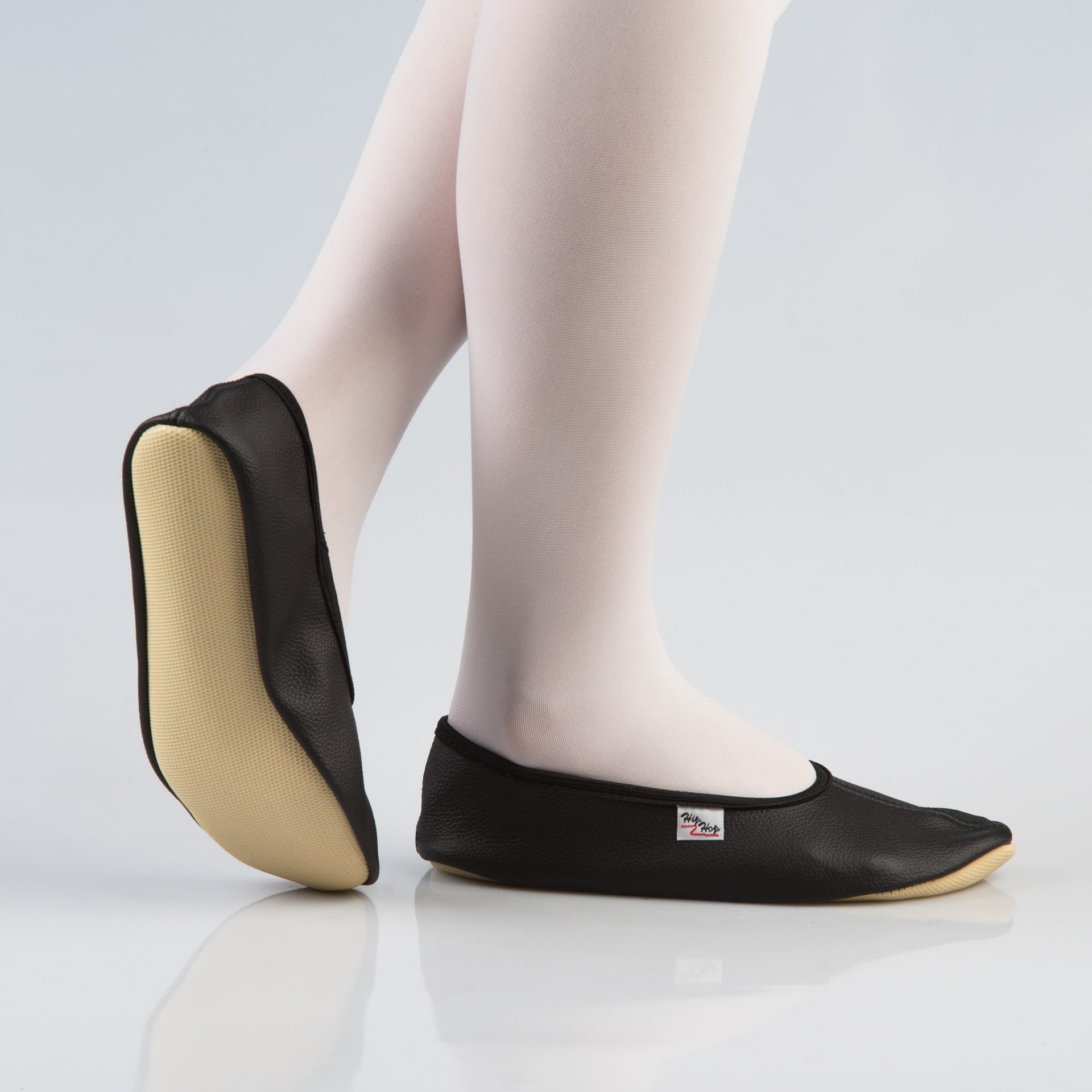 bold black leather gymnastics slippers with a secure rubber ridge and sole for confident performance