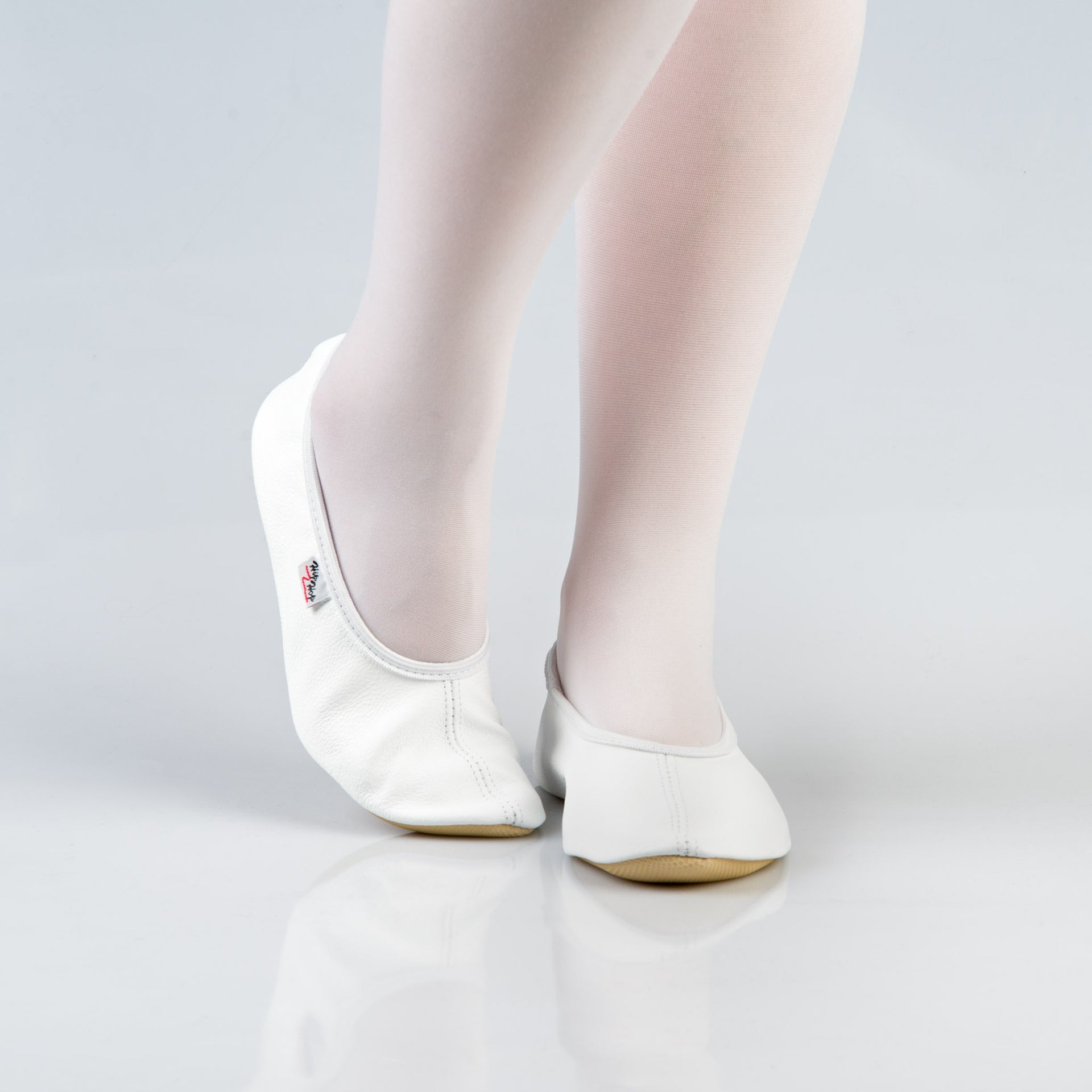 soft white leather gymnastics slipper with a secure rubber ridge and sole for comfort