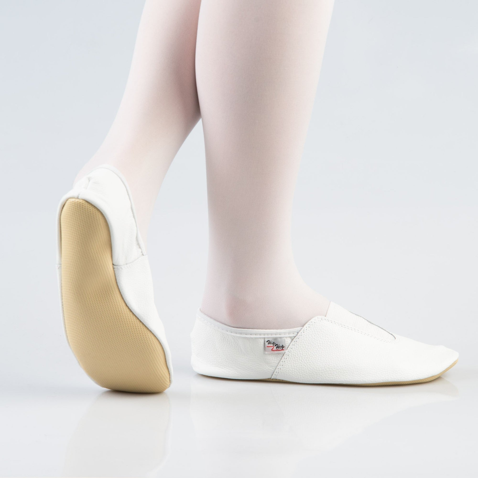 bold white leather gymnastics slippers with sleek rubber detail and sole for confident young dancers