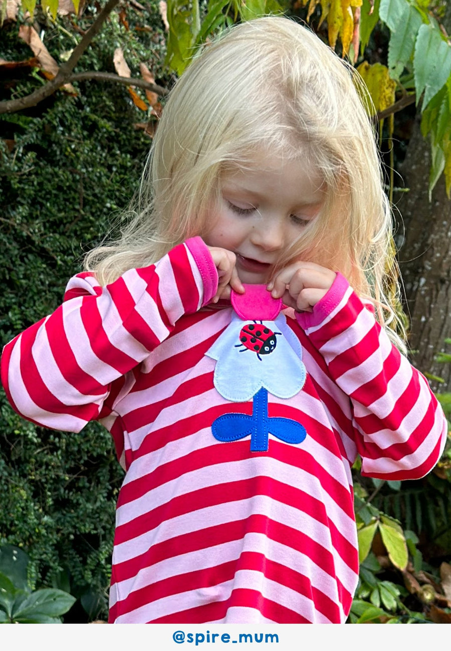Vibrant Flower Power Pink Striped Organic Cotton Long Sleeve Shirt with Retro Floral Applique and Interactive Ladybug Flap by Toby Tiger at brixbailey.com
