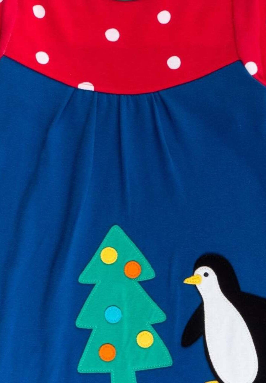 Premium dark blue Christmas dress with penguin applique, long sleeves, red-white polka dot yoke, GOTS certified organic cotton by Toby Tiger at brixbailey.com