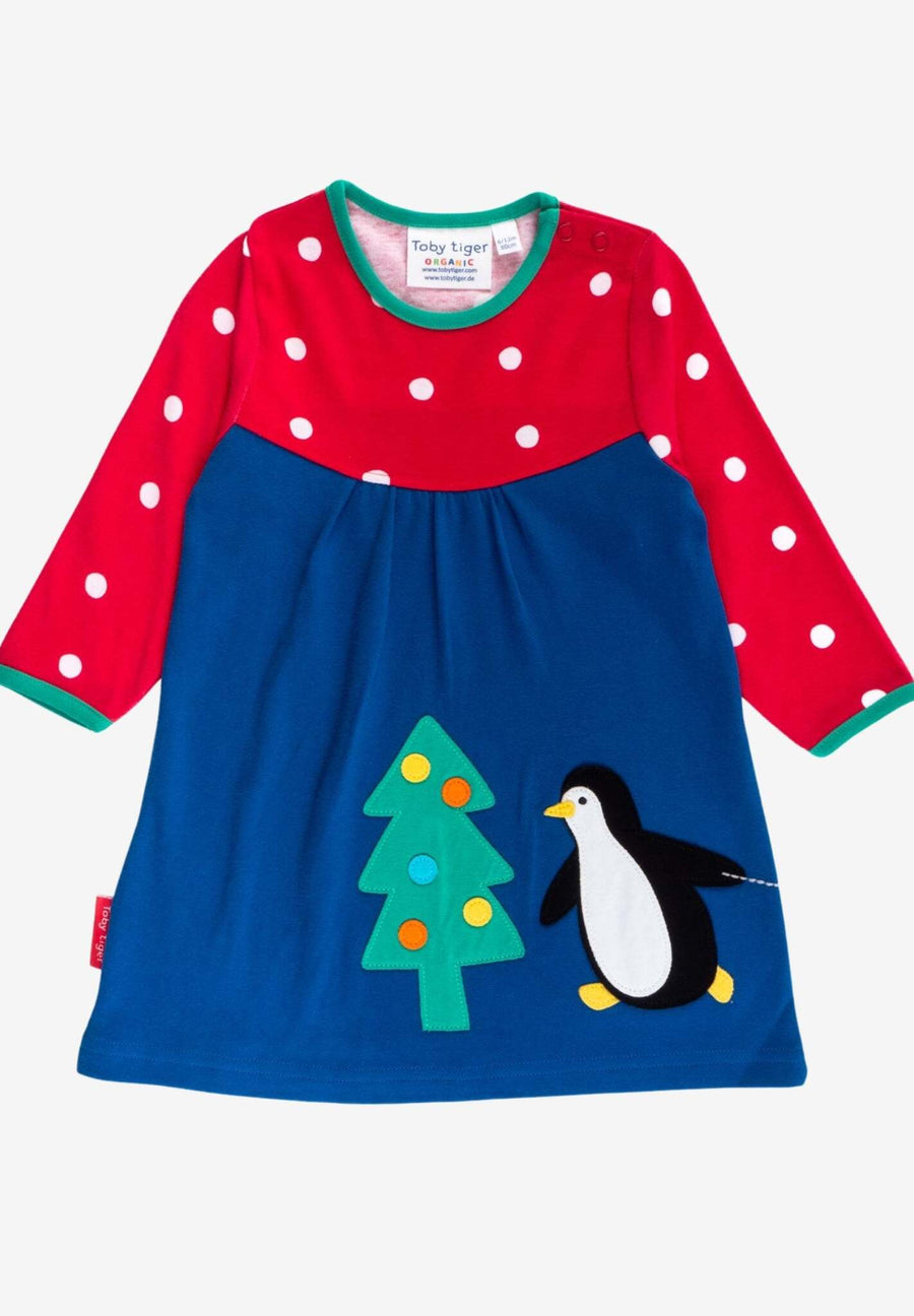Premium dark blue Christmas dress with penguin applique, long sleeves, red-white polka dot yoke, GOTS certified organic cotton by Toby Tiger at brixbailey.com