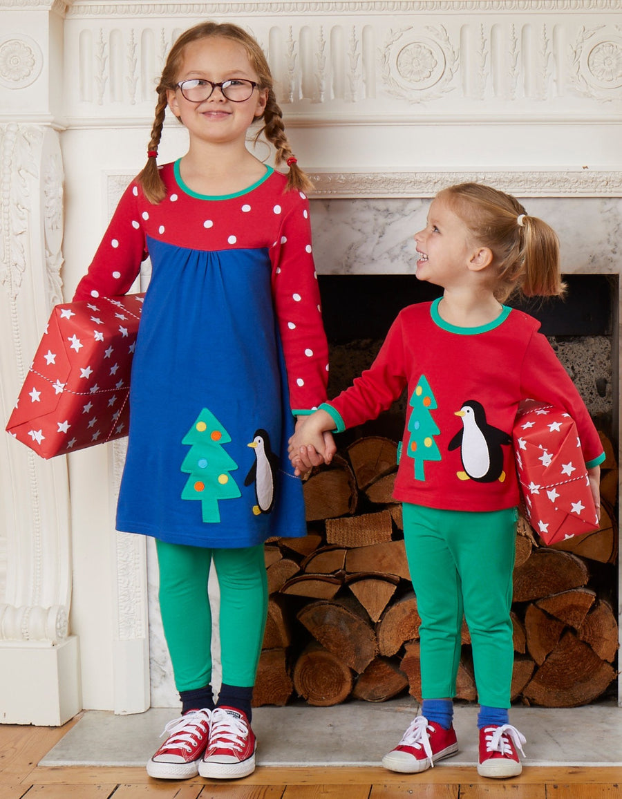 Premium dark blue Christmas dress with penguin applique, long sleeves, red-white polka dot yoke, GOTS certified organic cotton by Toby Tiger at brixbailey.com