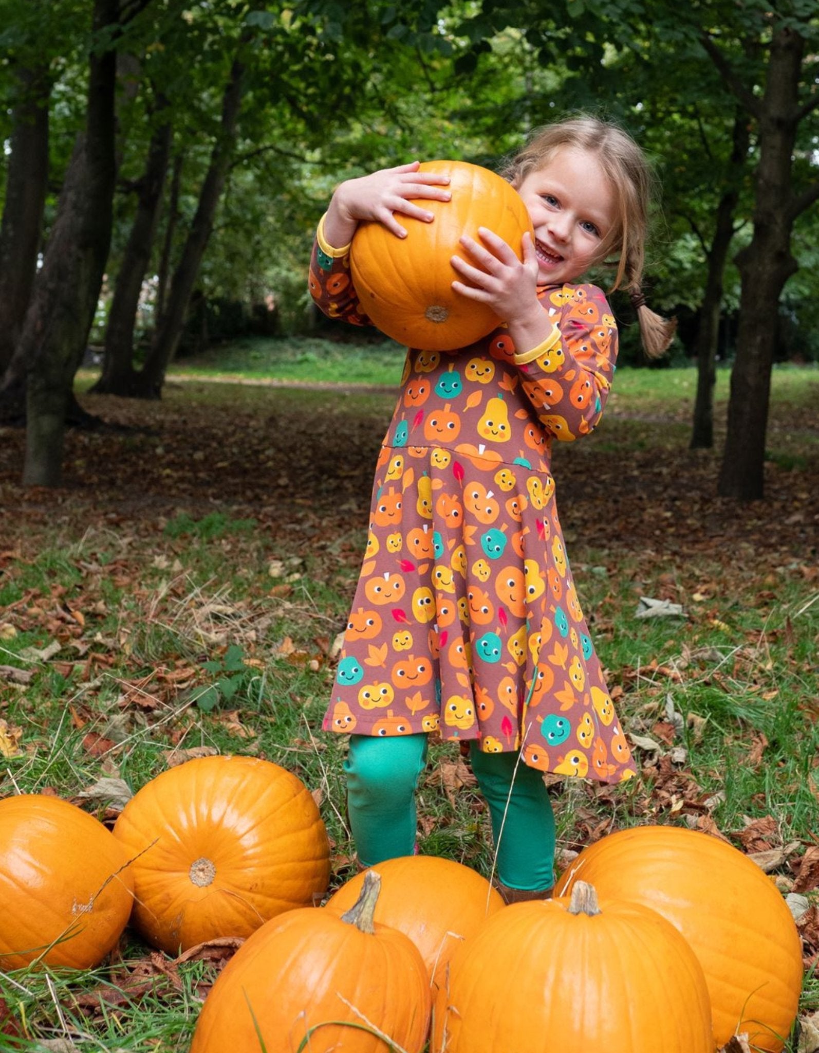 Premium organic cotton kids pumpkin skater dress, long sleeve Halloween outfit, soft GOTS-certified eco-friendly fabric, stylish autumn wardrobe essential by Toby Tiger at brixbailey.com