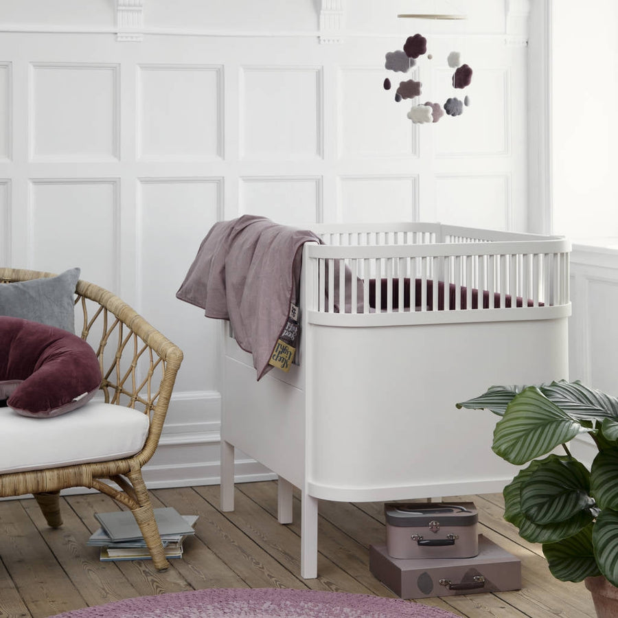 Premium white Sebra baby and junior cot bed, luxury handcrafted beech wood, adjustable mattress, non-toxic paint, best-selling nursery furniture by Ella James at brixbailey.com