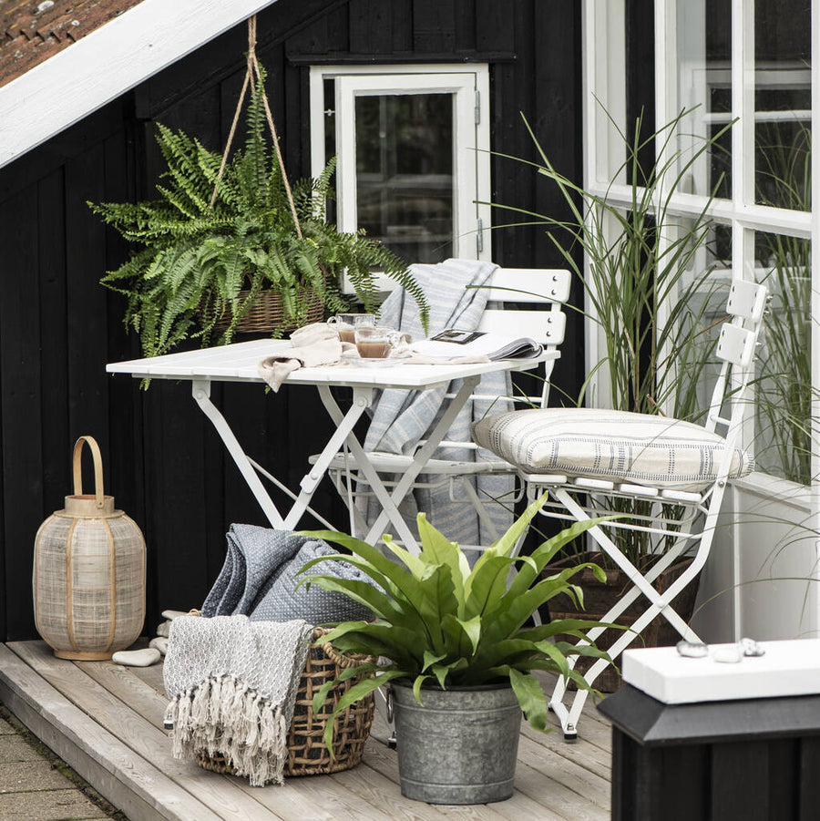 Modern white metal bistro table and chairs set, stylish folding patio furniture for balcony or garden, compact and space-saving by Ella James at brixbailey.com