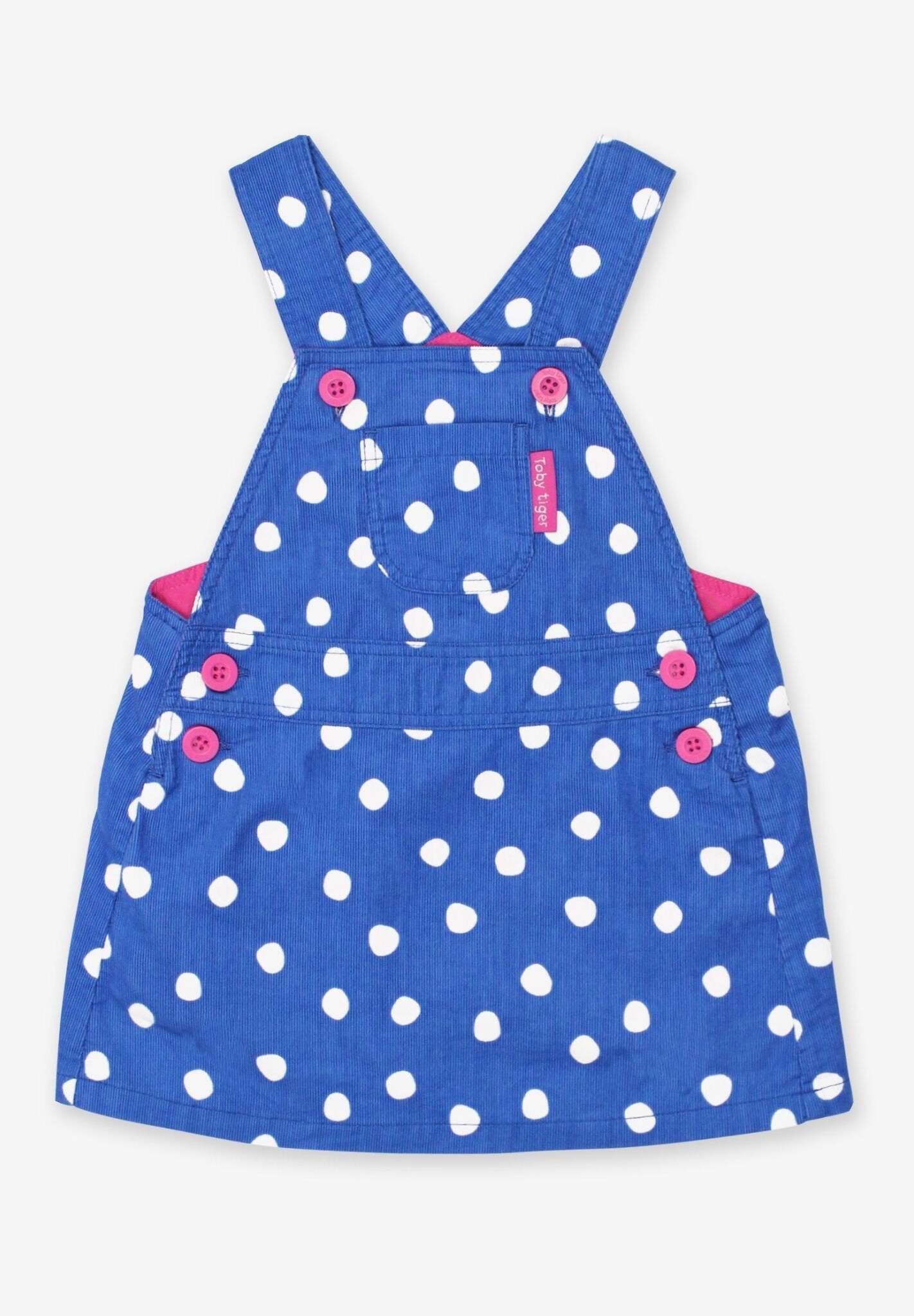 Premium blue corduroy pinafore dress with white dots, organic cotton, adjustable straps, front pocket, machine washable by Toby Tiger at brixbailey.com