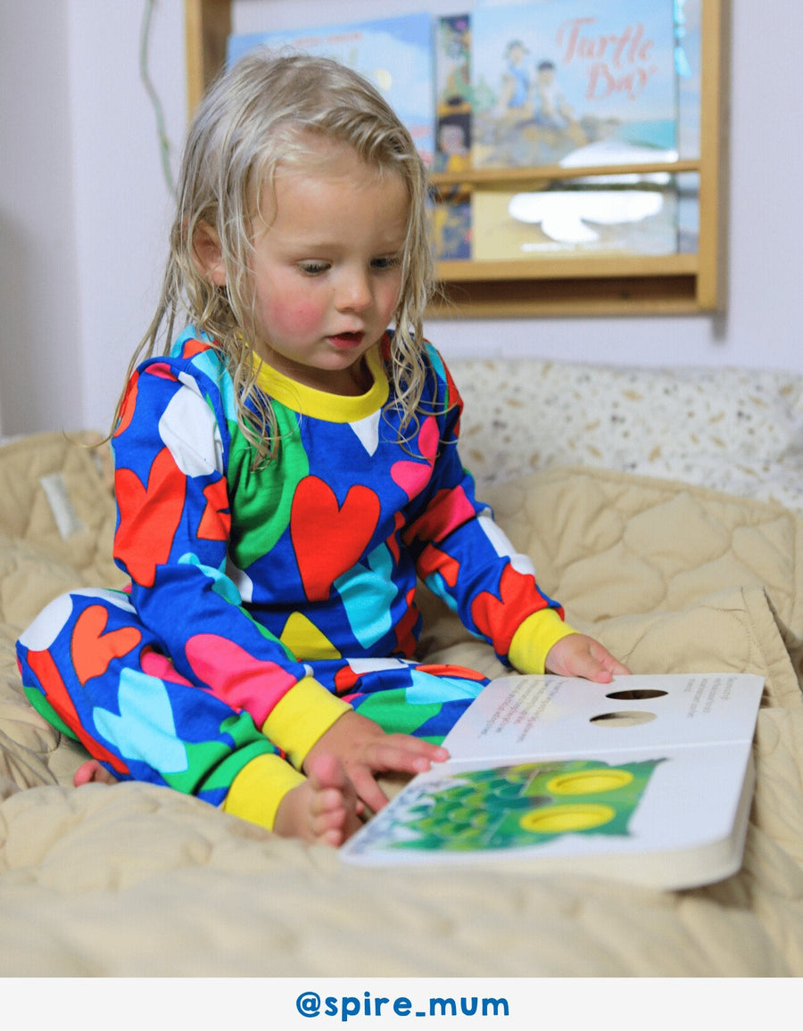 Luxury organic cotton pajamas with hand-drawn heart print, soft blue Toby Tiger fabric, bright yellow trim, premium comfort by Toby Tiger at brixbailey.com