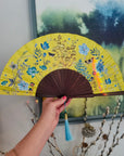 Bright yellow  'Luciferin' silk folding hand fan with flowers and mushroom painted artwork