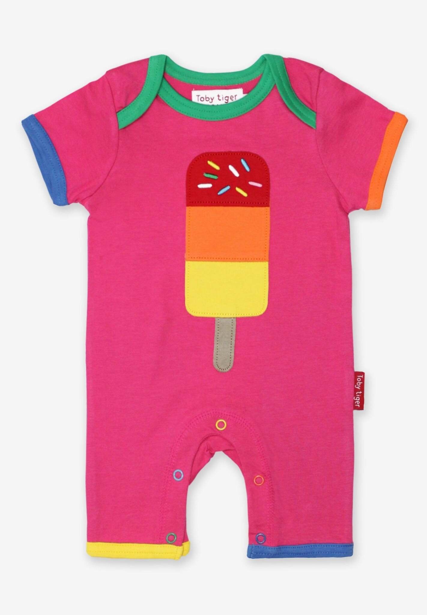 Luxury summer baby romper with lollipop applique, premium organic cotton, stylish pink with contrasting trim, short sleeves, snap buttons by Toby Tiger at brixbailey.com