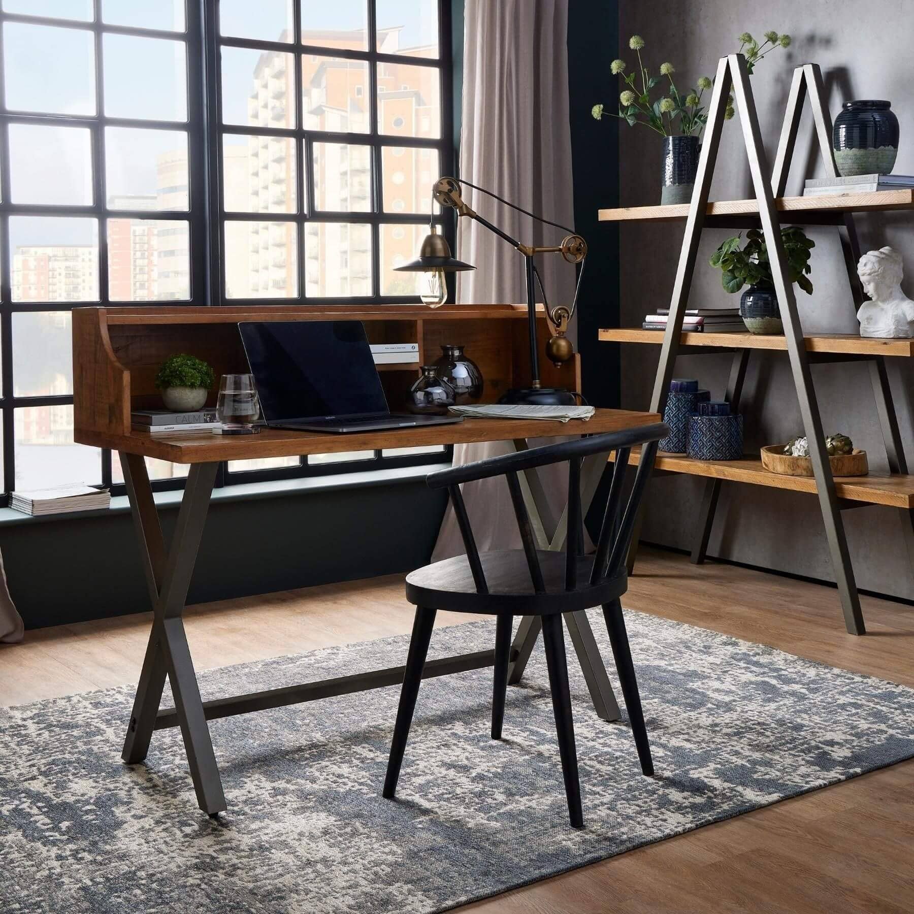 Modern home office with wooden desk, chair, and bookshelf.