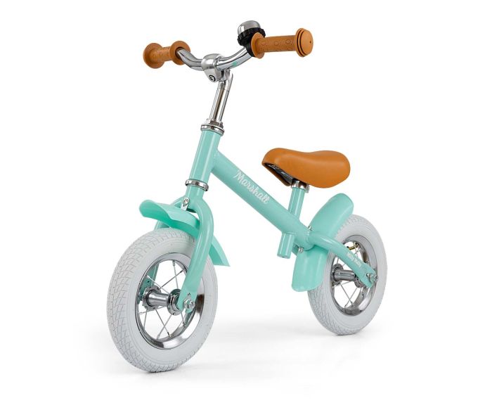 a child&#39;s marshall balance bike on a sun-drenched garden path, ready for a new adventure