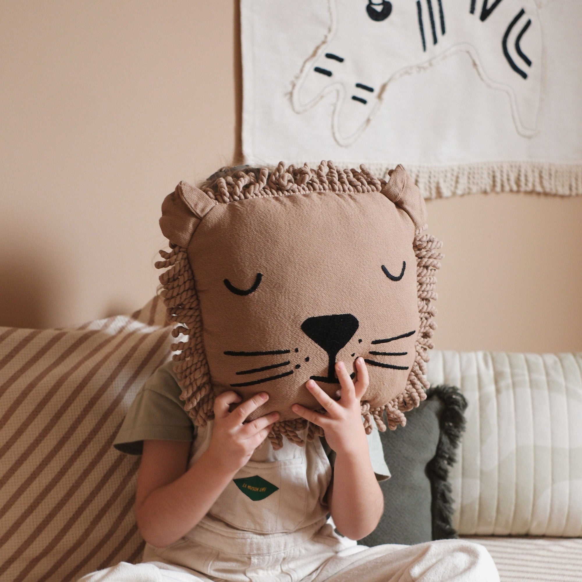Premium Nobodinoz lion cushion with sleepy face embroidery and curly fringe, soft plush toy for kids by Ella James at brixbailey.com