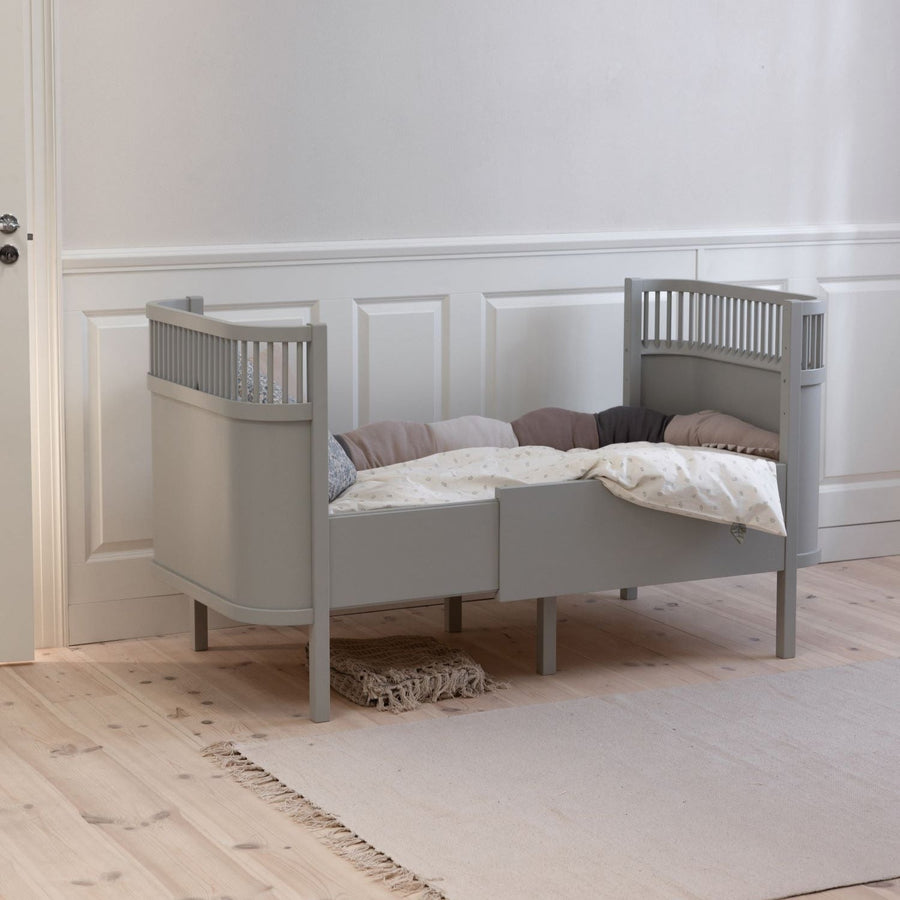Premium Sebra baby and junior cot bed in stylish stone grey, luxury Nordic beech wood design with adjustable mattress and height-adjustable base by Ella James at brixbailey.com