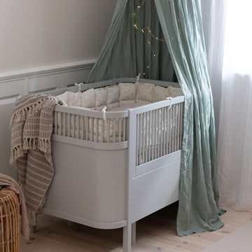 Premium Sebra baby and junior cot bed in stylish stone grey, luxury handcrafted beech wood, adjustable height, non-toxic paint by Ella James at brixbailey.com