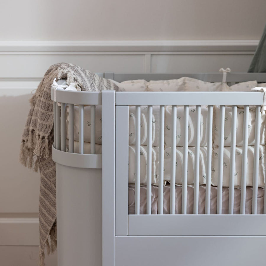 Premium Sebra baby and junior cot bed in stylish stone grey, luxury handcrafted beech wood, adjustable height, convertible design by Ella James at brixbailey.com