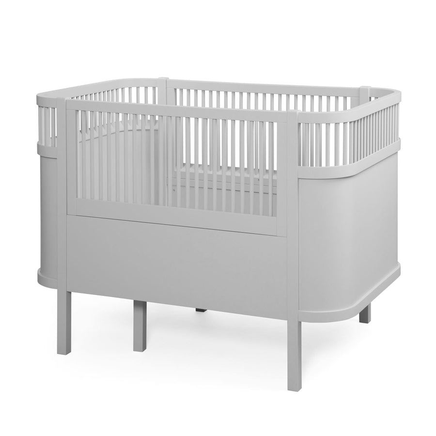 Premium Sebra baby and junior cot bed in stylish stone grey, luxury handcrafted beech wood with adjustable mattress, best-selling Nordic design by Ella James at brixbailey.com