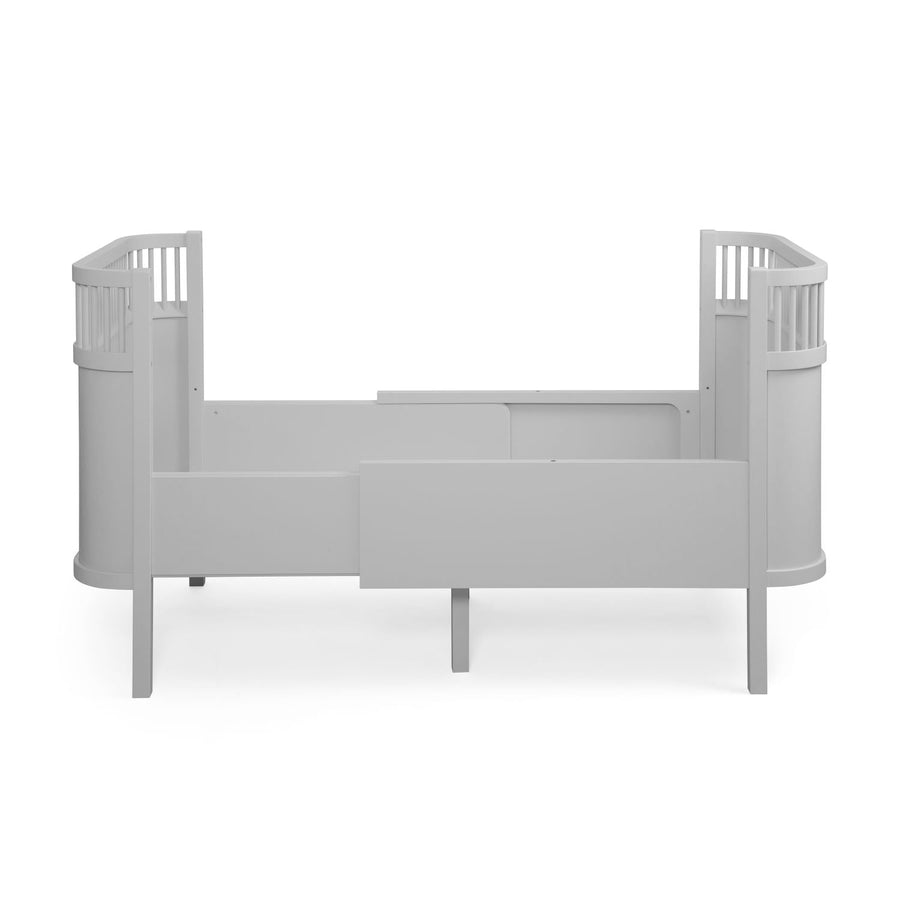 Premium Sebra baby and junior cot bed in stylish stone grey, luxury beech wood design with adjustable mattress and height-adjustable base by Ella James at brixbailey.com