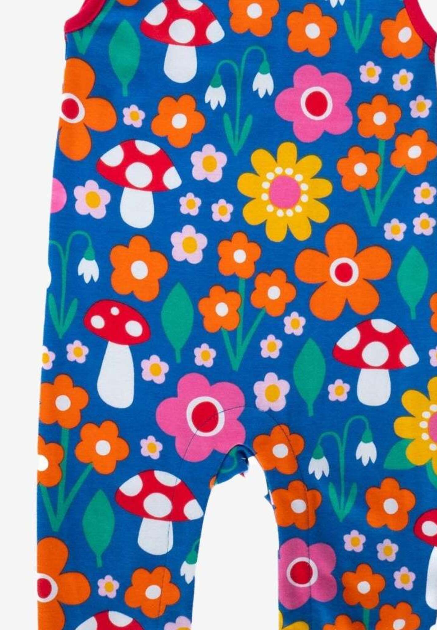 Premium organic cotton baby overall with floral mushroom print, red ankle bands, snap buttons, soft GOTS-certified fabric by Toby Tiger at brixbailey.com