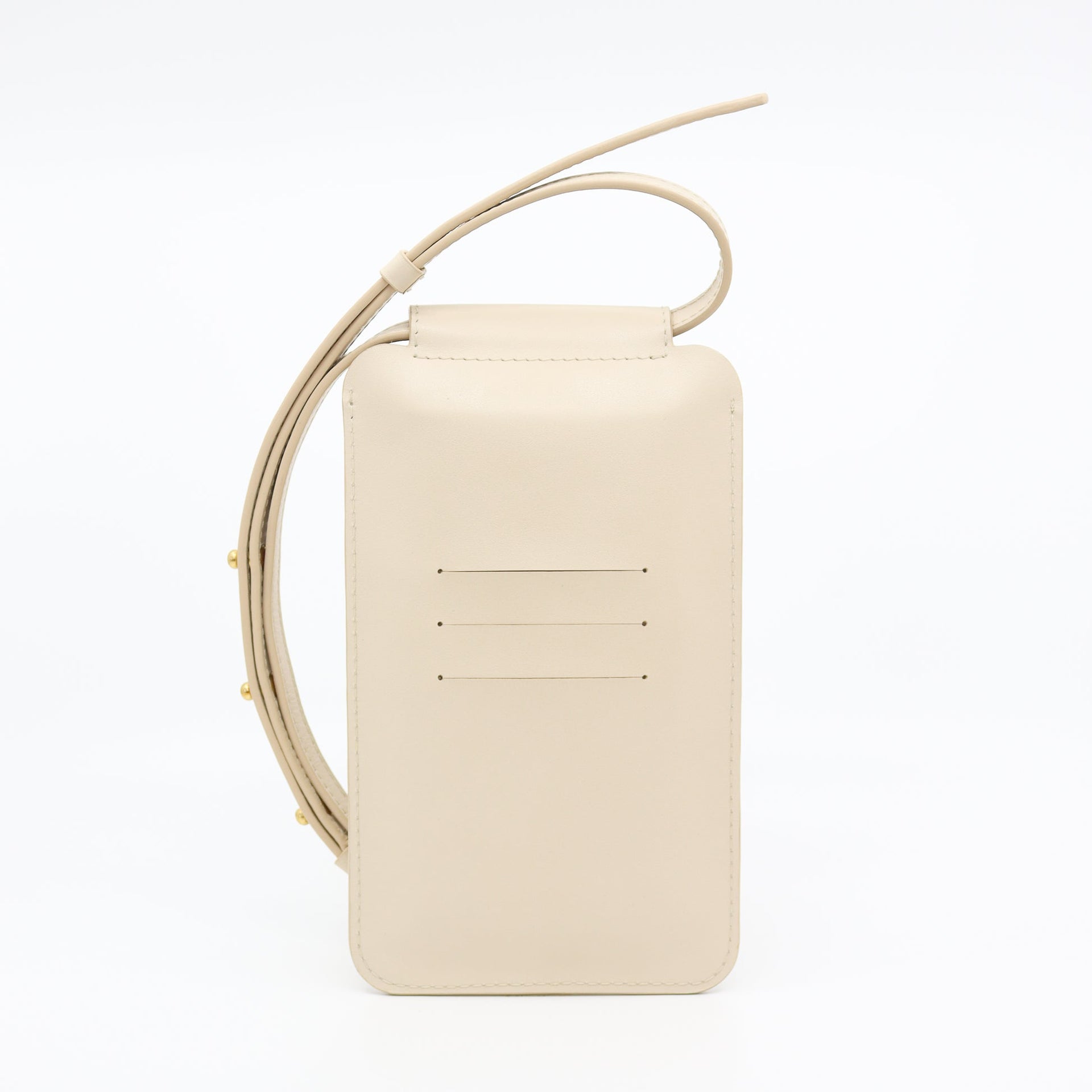 playful beige leather crossbody phone bag with gold buttons on a sunny day