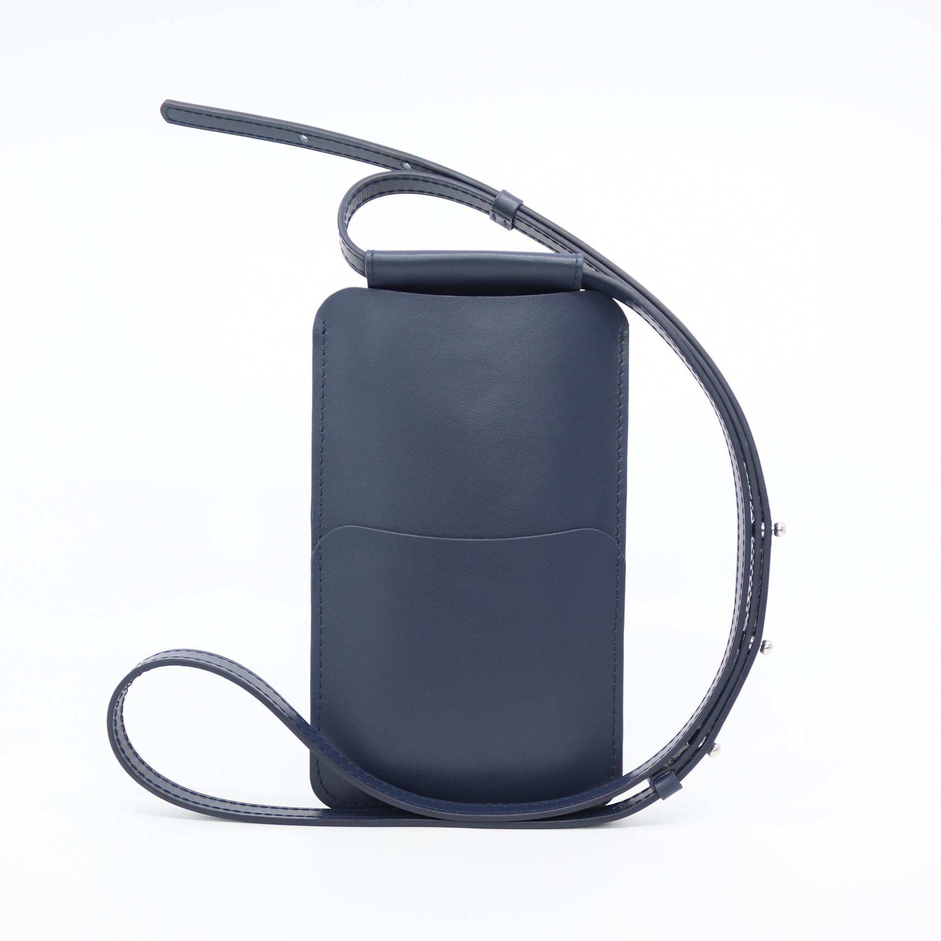 bold navy leather phone bag with gold hardware on a model, showcasing its confident crossbody style