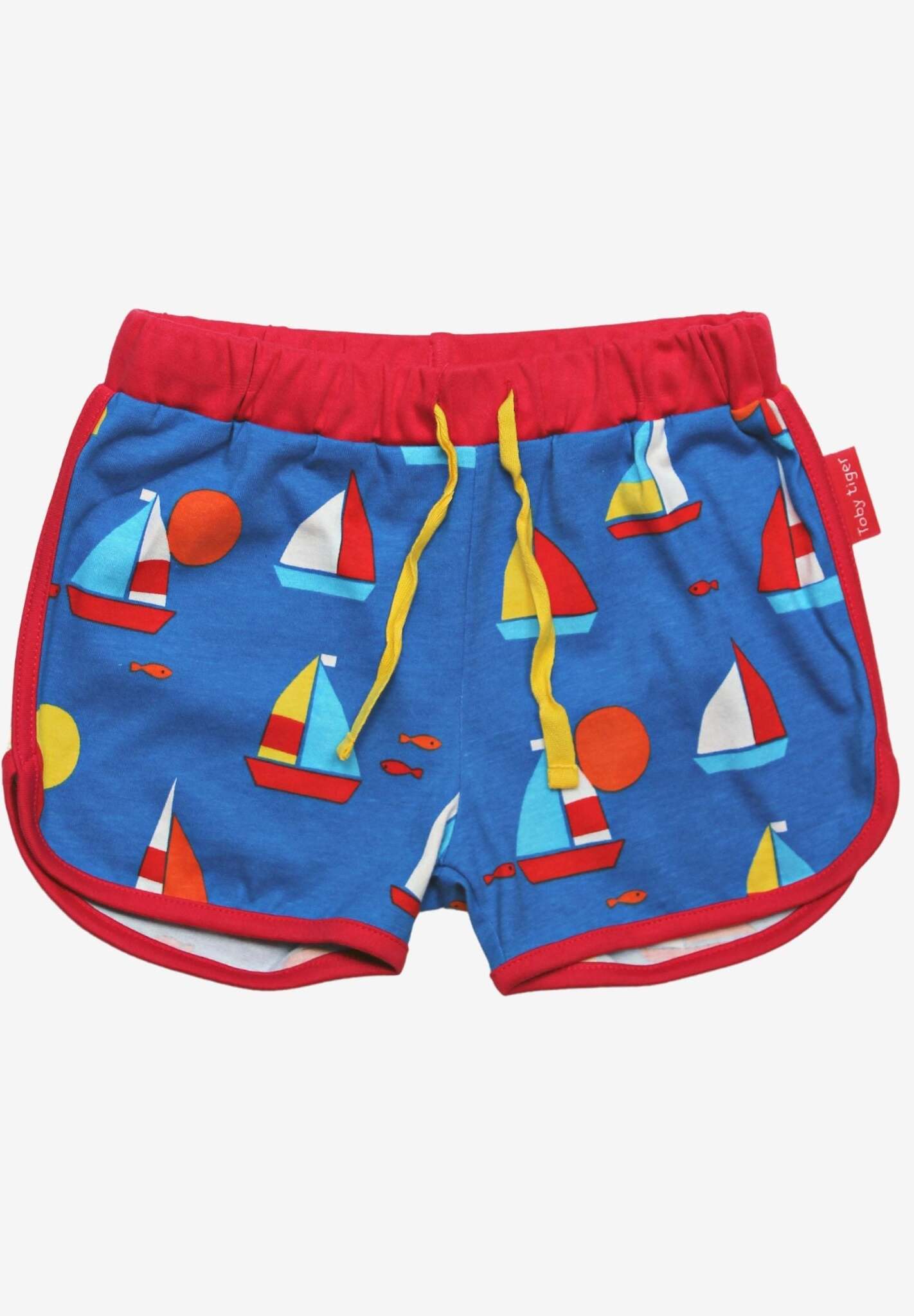 Premium organic sailboat print shorts, 100% GOTS certified cotton, red trim, adjustable yellow drawstring, stylish summer wear by Toby Tiger at brixbailey.com