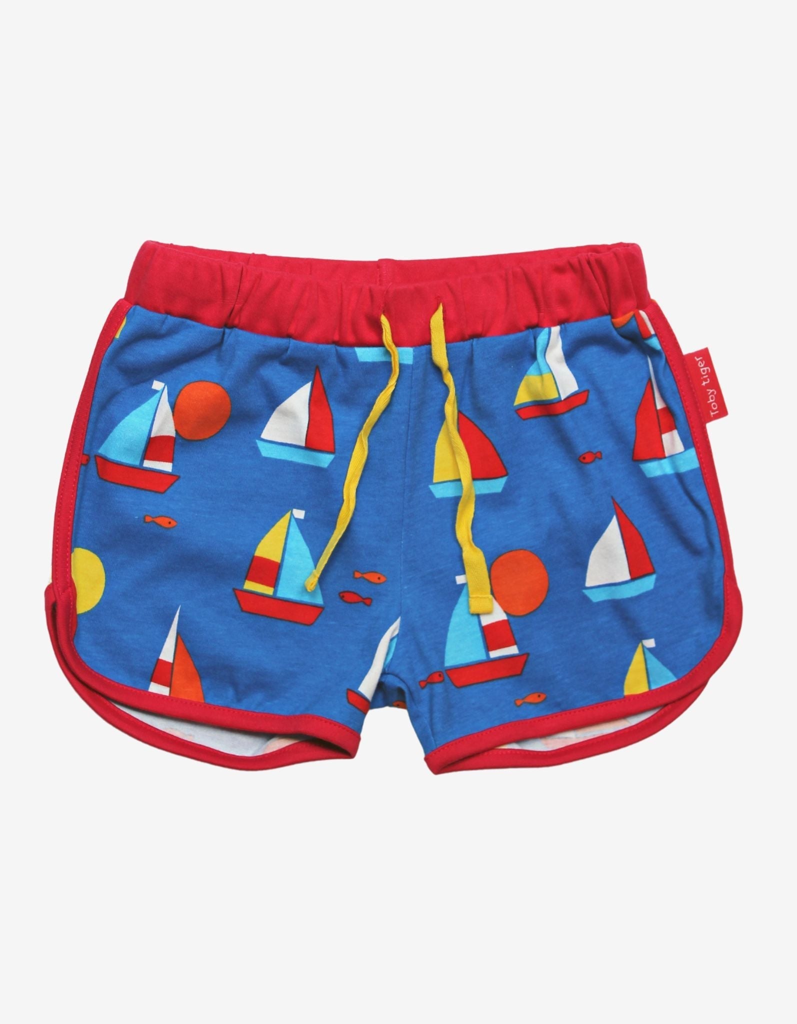 Premium organic sailboat print shorts, soft GOTS-certified cotton, adjustable drawstring waist, stylish red trim, trending summer fashion by Toby Tiger at brixbailey.com