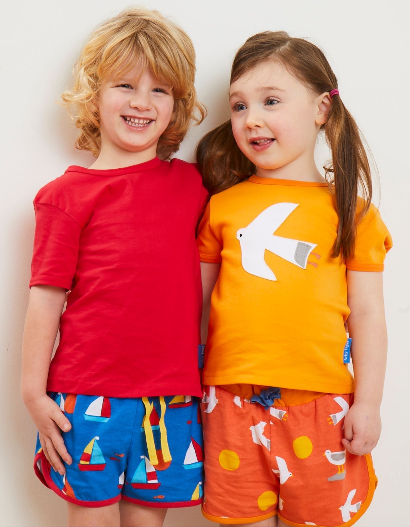 Luxury premium sailboat print organic cotton shorts, stylish red trim adjustable yellow drawstring, soft GOTS certified eco-friendly by Toby Tiger at brixbailey.com